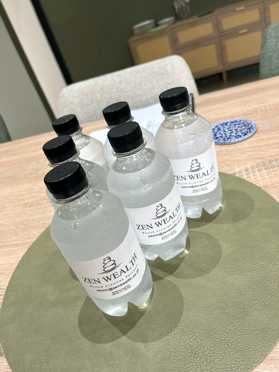 Zen Wealth branded spring water on the boardroom table